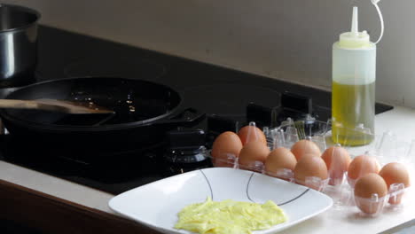 finished egg omelet- fried egg is on white plate on kitchen counter