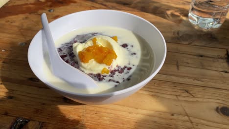 black sticky rice porridge topped with sweet ice cream looks fresh and delicious as a dessert.