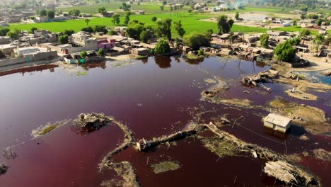 aerial view of dark red stale putrid floodwaters in daharki