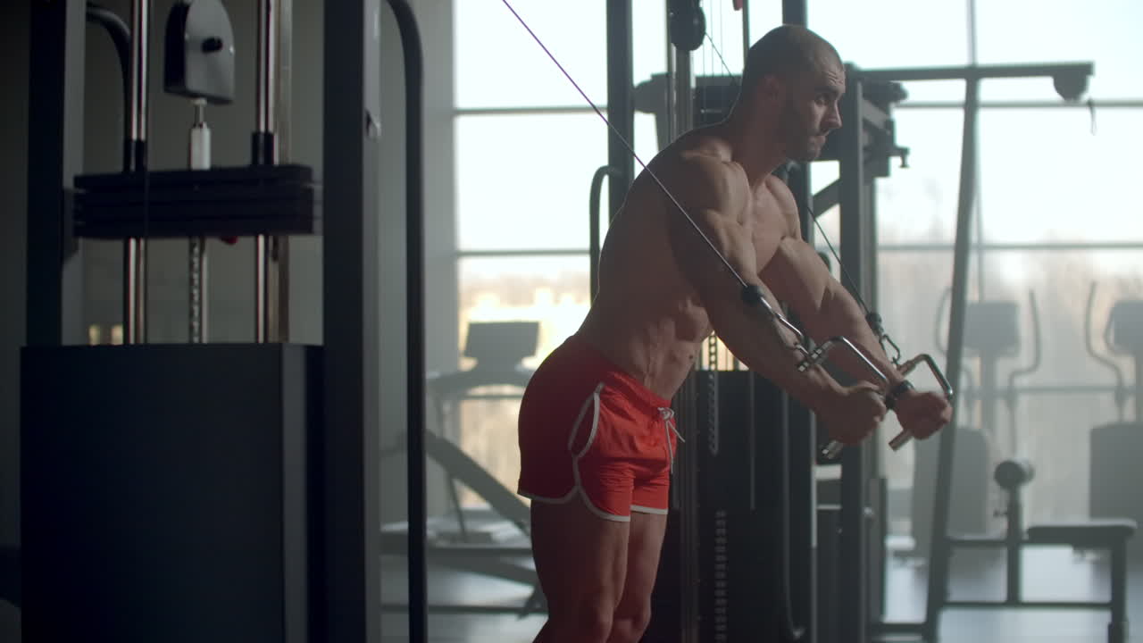 Young sportsman working out at the gym doing chest exercises on cable crossover machine motivation health strength sport.