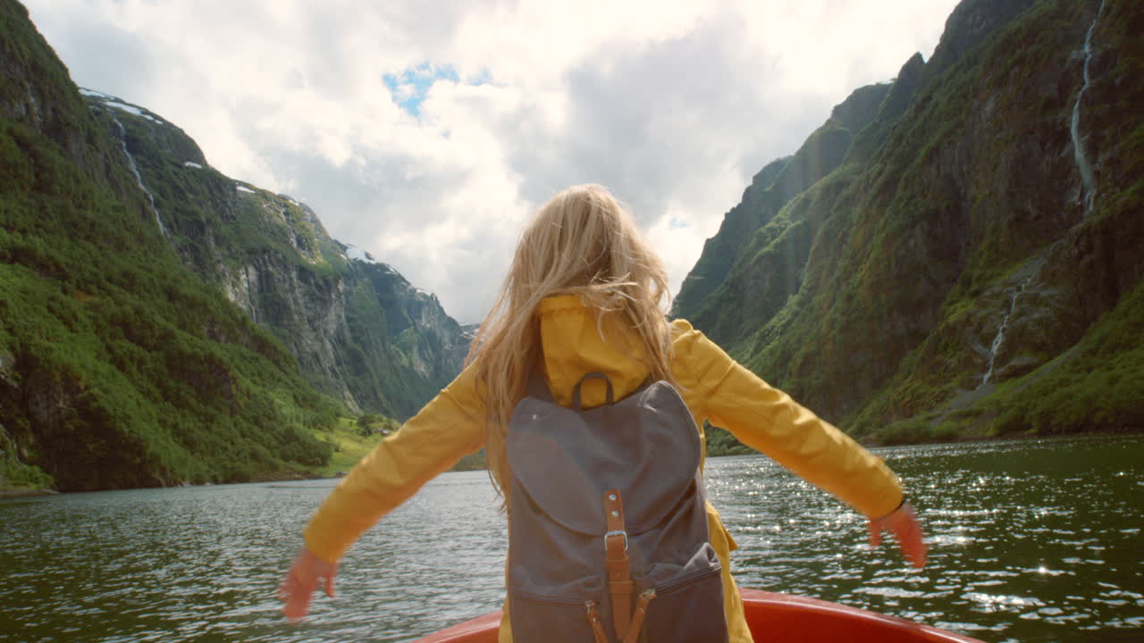 mujer disfrutando de los fiordos noruegos desde un barco