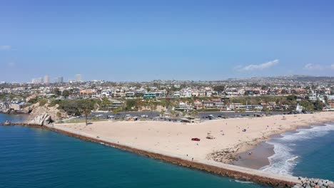 beachscape-of-Newport,-CA,-with-city-buildings-and-bay-estuary