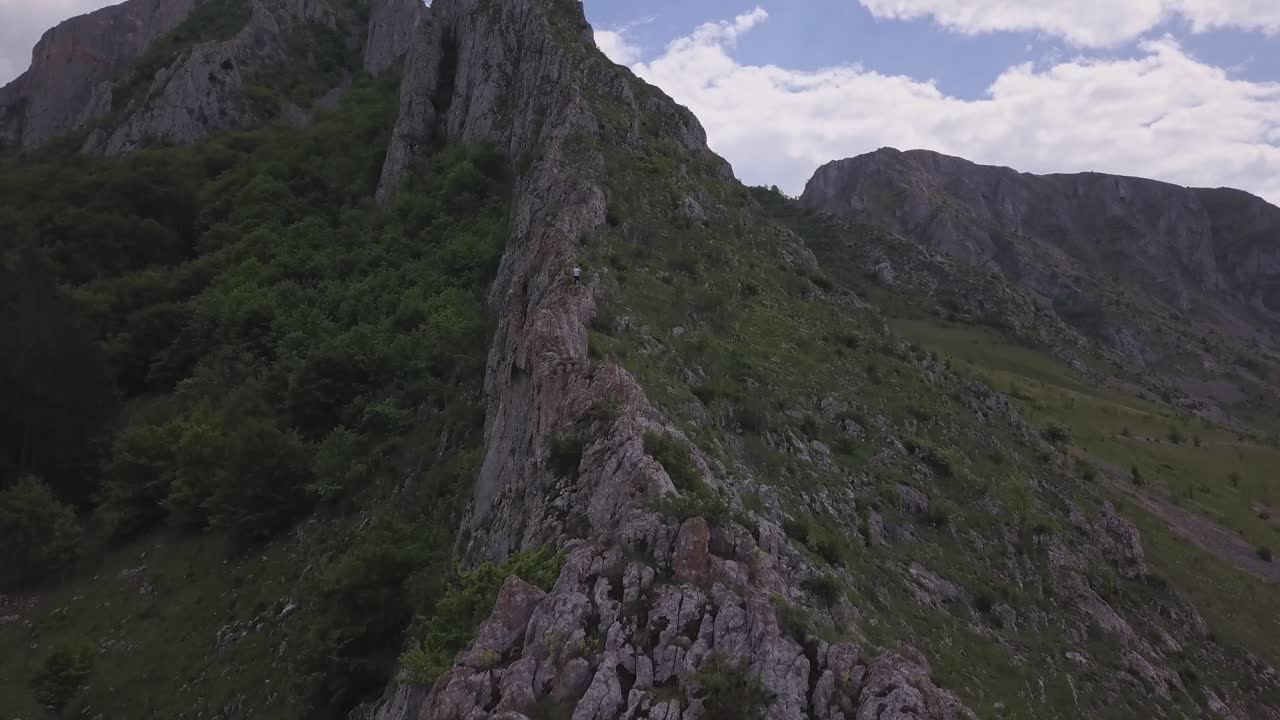 Aerial View Of Person Climbing Rocky Steep Mountain, Mountaineering Adventure
