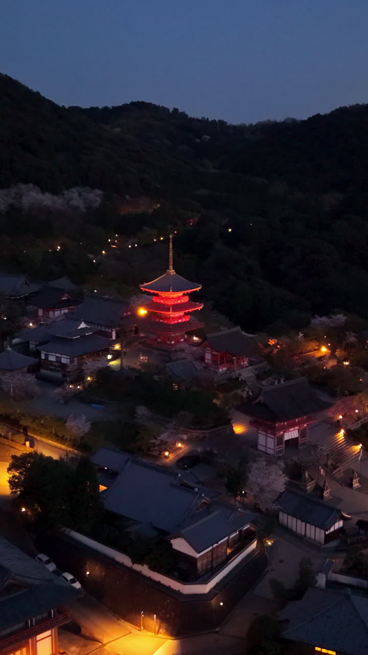 Aerial drone view of the illuminated Kiyomizu-dera temple in the evening in Kyoto, Japan