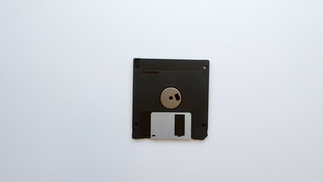 Zooming-out-from-an-old-vintage-floppy-disk-on-a-white-background