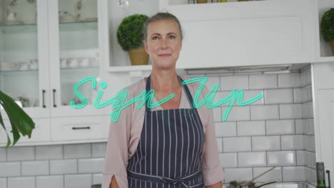wearing apron in kitchen, woman smiling with sign up text overlay animation