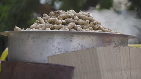 steaming hot groundnuts getting cooked in steel utensil