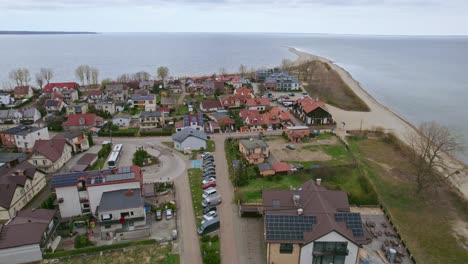 Aerial-shot-of-a-city-and-beach-in-Rewa,-Poland