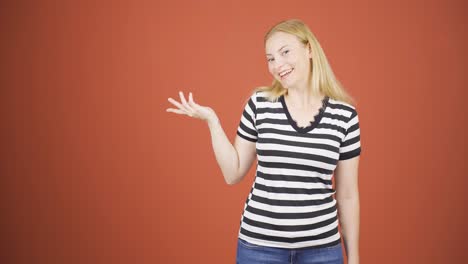 the woman promoting is pointing to the side and laughing.