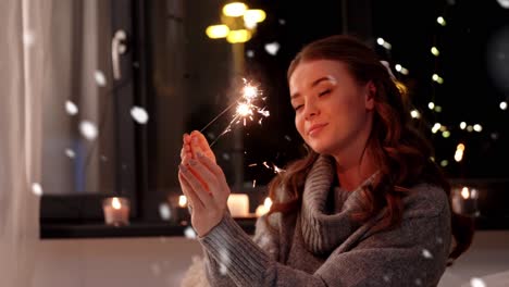 Happy-Young-Woman-Dancing-with-Sparklers.Happy-young-woman-dancing-with-sparklers-near-snowy-pine-trees