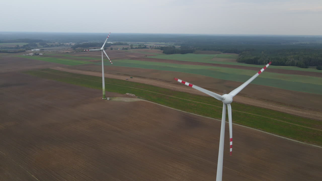 Small windmill farm standing on rural farm field in Poland