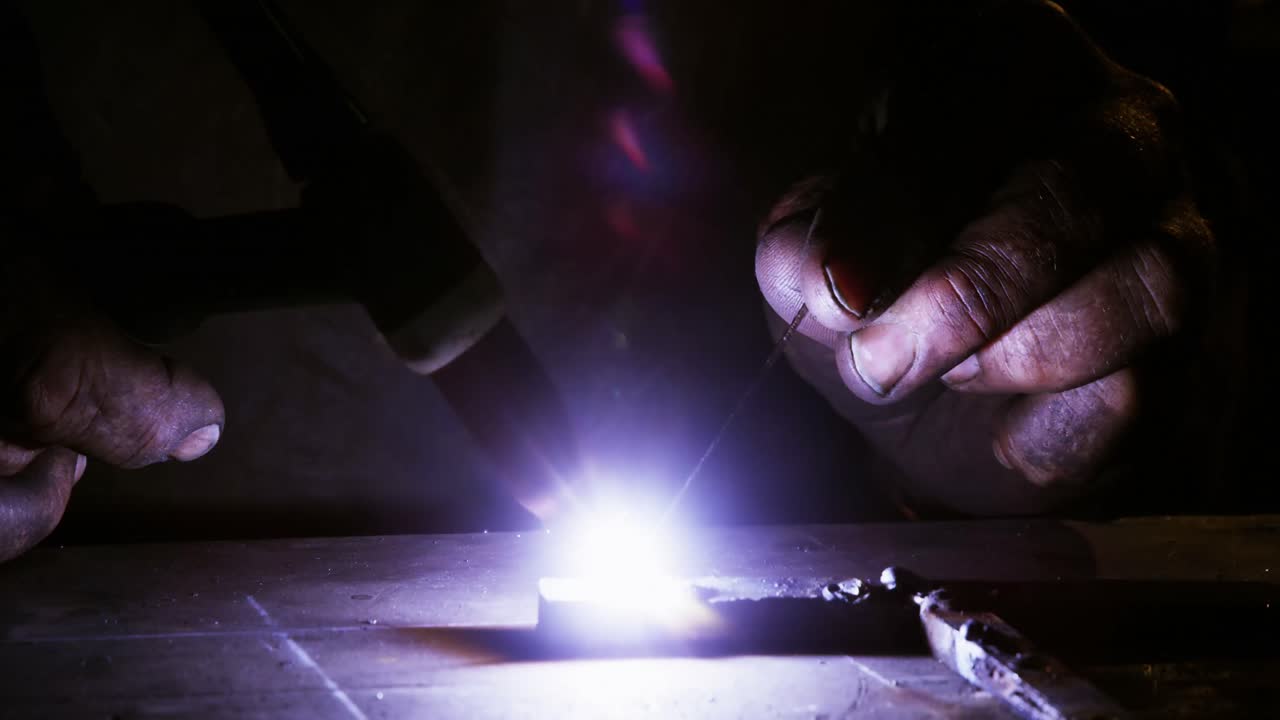Close-up of welder using welding torch
