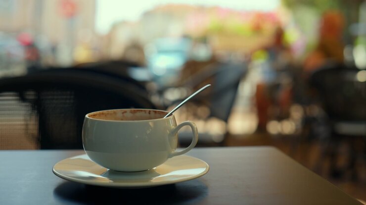 Relaxing moment with a finished coffee beverage, enjoying outdoor seating at a street cafe in the morning