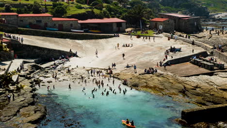 kayak reenters hermanus old harbour where people are