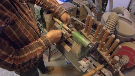 sanding wooden dowel rod on turning wooden lathe