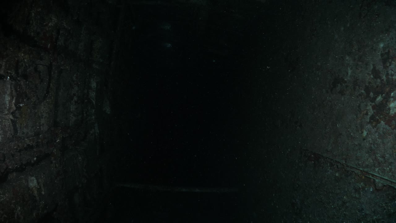 Unique underwater scuba divers view of the inside of a sunken shipwreck to reveal a dark chamber of the recently scuttled Australian Navy ship the Ex-HMAS Tobruk to provide an artificial reef
