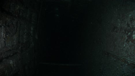 unique underwater scuba divers view of the inside of a sunken shipwreck to reveal a dark chamber of the recently scuttled australian navy ship the ex-hmas tobruk to provide an artificial reef