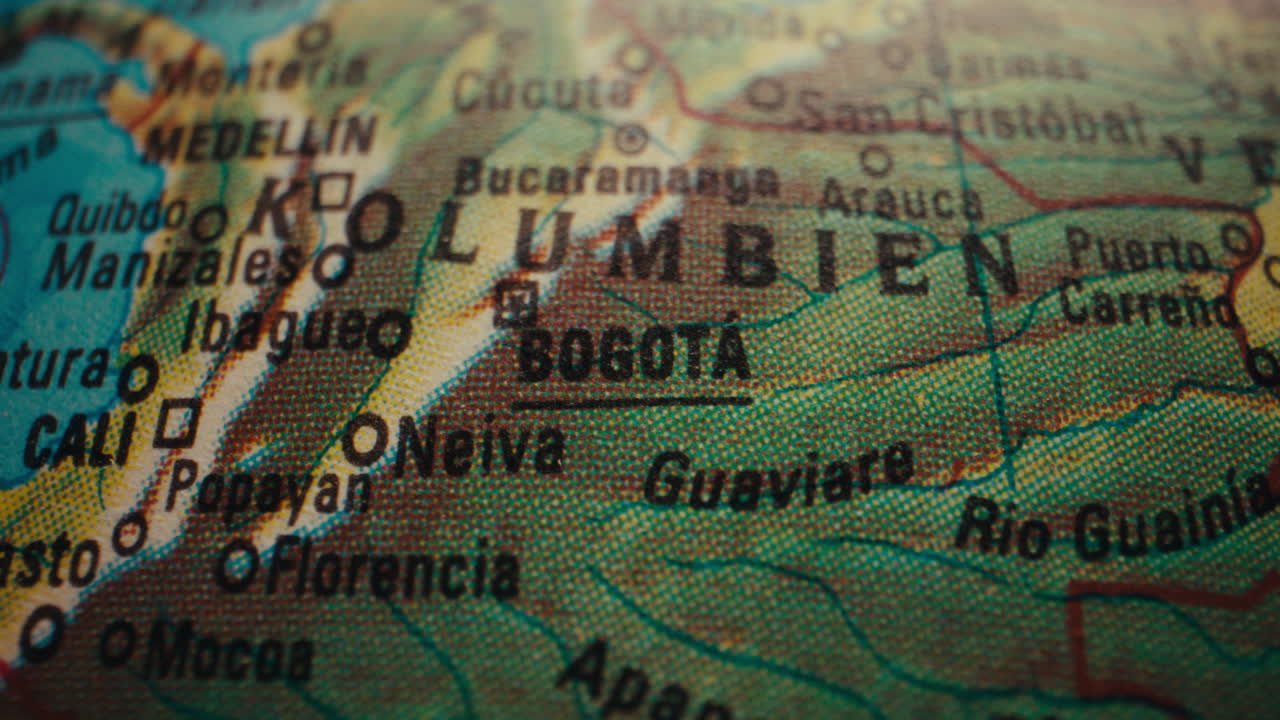 Close-up view of a world map, focusing on the location of Bogotá, Colombia.
