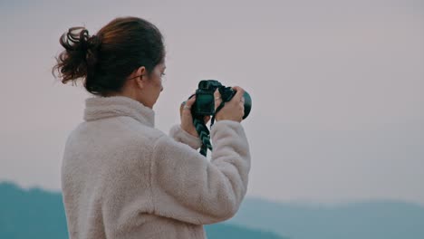 woman taking photo in nature