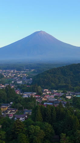 vertical drone shot of the fujikawaguchiko town and mt fuji, sunset in japan