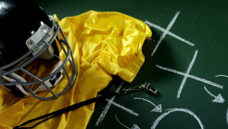 jersey, referee whistle and head gear on green board 4k