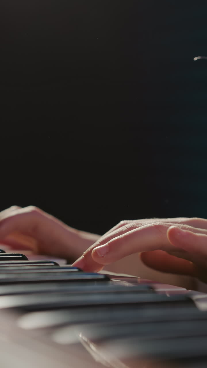 Girl delicately plays electric piano keyboard. Petite musician learns notes in audio recording studio during musical lessons. Next wave of musical artists