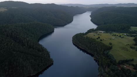 tilt drone shot of tranquil lake barrington on calm overcast day near sheffield in tasmania, australia