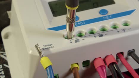 Incoming wires are attached to solar power controller, closeup view