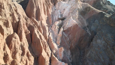 An-abandoned-magnesium-mine-sits-in-ruin-along-the-colorful-formations-of-Afton-Canyon,-California