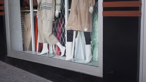 a storefront window with mannequins displaying clothing