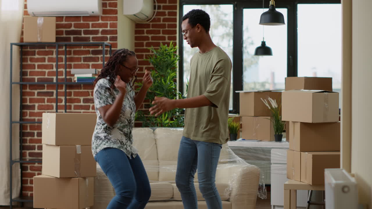 African american partners having fun dancing in living room