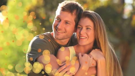 couple in the garden surrounded by an animation of orange bubbles