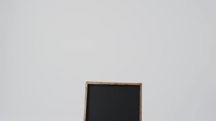 Video of blackboard sign on wooden stand with copy space on white background