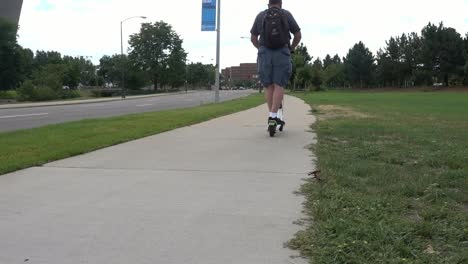 a man passing by on an electric scooter in denver