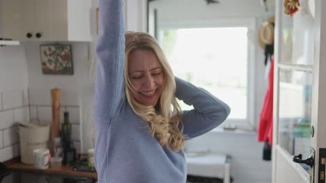 a woman in a kitchen smiling