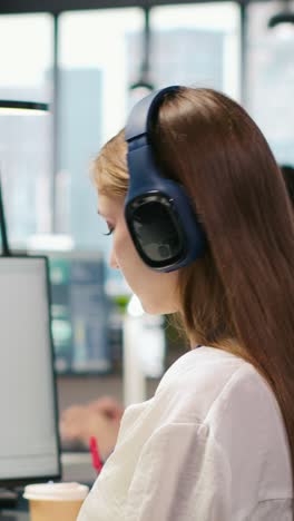 vertical video engineer coding with ai language model assistance in office, listening music