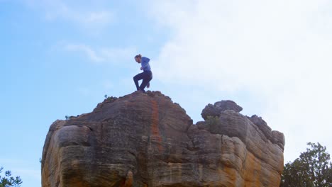 Male-hiker-running-in-rocky-mountain-4k