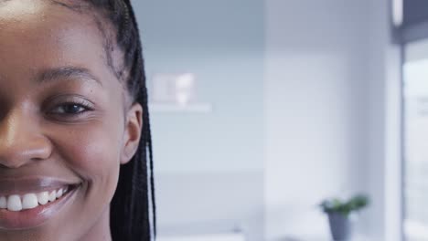 Half-portrait-of-happy-african-american-female-patient-in-hospital-room-with-copy-space,-slow-motion