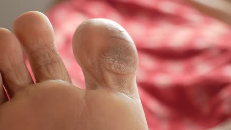 Close-up-of-young-women-dry-feet-on-bed