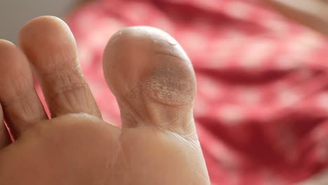 close up of young women dry feet on bed