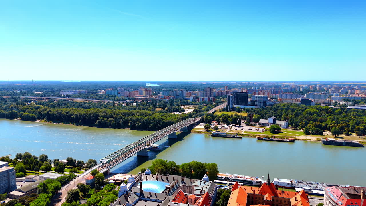 The Old Bridge connecting the banks of Bratislava, Slovakia. Drone footage over the historical part of the beautiful city.