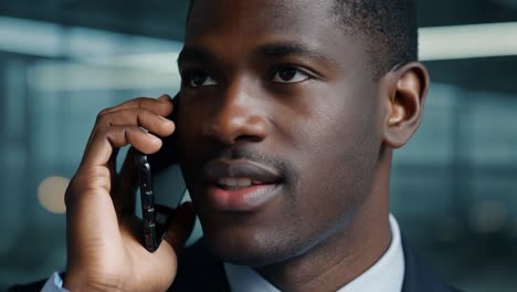 businessman engaging in a phone call while working in a modern office building, showcasing a professional atmosphere