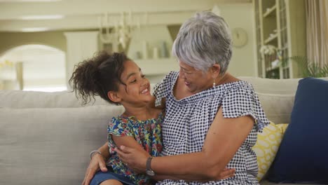 grandmother embracing her granddaughter at home