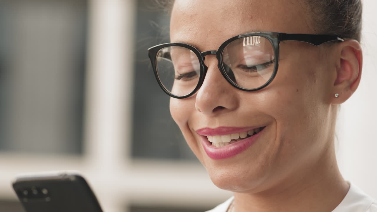 Woman using her phone and smiling