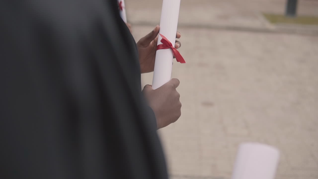 Diploma In The Hands Of A Black Female Graduate