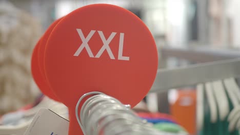 xxl size marker on a clothing rack in a retail store