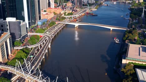 aerial view of kurilpa bridge over brisbane river in central business district of brisbane, queensland, australia