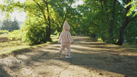 baby girl walking in a park