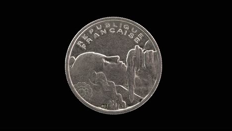 france 1955 100 francs coin obverse with the bust of liberty holding a torch rotating on black background