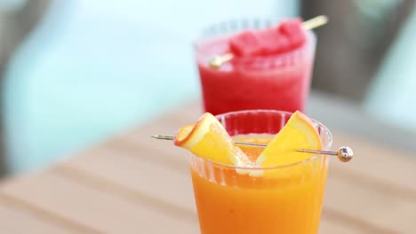 orange and watermelon juices on a wooden table